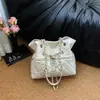Bolso pequeño tipo cubo con cadena de patrón de rombos estilo Chanel para mujer, estilo coreano de otoño, lujo ligero, simple y elegante, bolso de hombro versátil