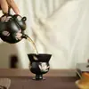 Taza de té de cerámica negra lisa con diseño pintado en oro, pintada a mano, adecuada para uso doméstico, para disfrutar del té y las ceremonias del té