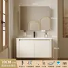 Tocador de baño engrosado y ahorrador de espacio con diseño en color crema, que cuenta con un lavabo redondeado, lavabo cerámico integrado y un lavabo de una sola pieza.