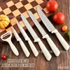 Conjunto de facas de aço inoxidável com sete peças, apresentando cabo horizontal e um bloco de facas quadrado, um conjunto de facas de cozinha de 7 peças