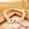 Europa y Estados Unidos pulsera de piedra de ojo de gato blanca transfronteriza para niñas alta gama moda Joker círculo único pulsera de cuentas redondas joyería al por mayor
