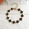 Nuevo Conjunto de Collar y Pulsera de Trébol de Cuatro Hojas con Diamantes Completos Transfronterizo, Exquisito y Lujoso, Sensación de Alta Gama, Conjunto de Joyería de Cadena para Clavícula de Nicho para Mujeres