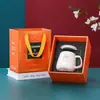 Juego de tazas de cerámica naranja con tapa y cuchara taza moda creativa dibujos animados Taza juego de regalo al por mayor imprimible