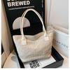 Bolso tipo cubo tejido retro de color contrastante 2025 Verano Nueva tendencia de moda Bolso tote de hombro para dama Vacaciones de playa