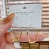 Pendientes de botón geométricos metálicos cruzados estilo europeo y americano, diseño de nicho, sentido del temperamento, para celebridades de internet, para ir al trabajo, accesorios de oreja versátiles