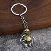 Novedad creativa robot de dibujos animados móvil aleación cráneo bronce colgante llavero pequeña joyería