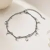 Pulsera cruzada de acero inoxidable de doble capa con estrella y luna europea y americana, acero de titanio, no se decolora, joyería de nicho de lujo ligero para parejas al por mayor