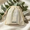 Bolsa de algodón puro estilo Zen color beige hecha a medida con cordón para aceites esenciales y polvo liofilizado, duradera y relajada con texto impreso