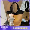 Bolso de mano coreano para el trabajo, nuevo para la primavera de 2026, transfronterizo, gran capacidad, diseño exclusivo, moderno y versátil, tipo cubo para el trabajo