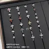 Nuevos y modernos aretes de cruz con diamantes completos Jiuhan para mujer, ear cuffs de acero de titanio de nicho, populares tachuelas de hueso de la oreja de alta gama