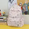 Mochila para estudiantes de preparatoria y universidad con graffiti transfronterizo, mochila versátil de nicho con estampado de estrellas, mochila de gran capacidad para mujer