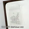 Decoraciones para uñas con temática oceánica: Diseños de estrellas de mar doradas y plateadas, conchas marinas y cocoteros en estilo japonés, con adornos metálicos para uñas.