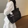 Bolso de lona de moda para mujer 2026 nuevo modelo de gran capacidad, bolso tote simple para estudiantes universitarios, bolso de mano para ir a clase, bolso de hombro