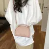 Bolso tejido de lujo ligero de estilo coreano de nicho para mujer, bolso casual tipo concha para el verano 2026, bolso de hombro y cruzado de alta gama