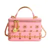 Bolsa de maquillaje mini labial más vendida transfronteriza, bolso de mano con cadena de cuentas europeo y americano, bolso de mujer con tachuelas, suministro de comercio exterior al por mayor