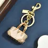 Llavero de minibolso con incrustaciones de diamantes transfronterizo, colgante de aleación de esmalte multicolor, accesorio de bolso versátil de lujo ligero, regalo