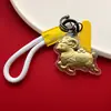 Ouro Ano do Carneiro Fique Rico Ovelhinha Ovelha Correndo Reunião de Riqueza Chaveiro Cordão de Celular Bolsa Pingente Dourado Presente Comemorativo Atacado