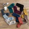 Calcetines de rizo para hombre y mujer calcetines de invierno de tubo grueso calcetines de lana de anillo calcetines de mujer color liso calcetines de toalla cálidos al por mayor