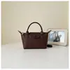 Bolsa de Mão Tecida Nova Tendência Verão 2026 Feminina Elegante Simples de Ombro Design de Personalidade Retrô Bolsa Transversal