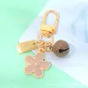 Chaveiro de Metal Pequena Flor Estilo Ins com Gotejamento de Óleo e Etiqueta Pequena Sino Pingente para Bolsa de Fone de Ouvido de Meninas