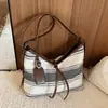 Bolso de mujer de alta gama transfronterizo, nuevo modelo verano 2026, bolsa de tela versátil casual de gran capacidad, bolso tipo cubo de un solo hombro cruzado