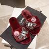 Pantuflas esponjosas de mariposa de diamante y flor coreanas de moda casual de otoño e invierno, pantuflas cálidas de felpa para el hogar al por mayor
