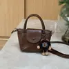 Bolso Pequeño Retro de Bloques de Color para Mujer 2026 Otoño/Invierno Nuevo Bolso de Mano de Alta Gama Simple Versátil para el Trabajo Bolso Cruzado de Moda