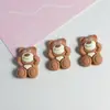 Venta caliente color café de arroz té de leche miu oso oso fresa moño funda para teléfono accesorios de resina fabricantes al por mayor