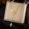 Elegante collar de corazón de doble capa, cadena de acero inoxidable chapada en oro de moda de nicho transfronterizo, cadena para la clavícula de lujo ligero para mujer