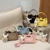 Bolso de hombro cruzado casual de diseño de nicho transfronterizo para mujer, nuevo bolso de cubo de mano de moda estilo coreano para el verano de 2026