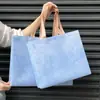 Bolsas de mano personalizadas, minimalistas y de gran capacidad para tiendas de ropa, bolsas de tela no tejida para guardar ropa, bolsas de regalo impresas a medida con acabado laminado