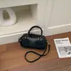 Bolsa de bolos para mujer, nuevo estilo coreano de moda primavera 2026, bolso de mano de alta gama versátil para el hombro y cruzado para el trabajo