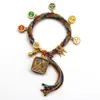 Pulseira do deus da riqueza de cinco vias estilo Xizang oito santos padroeiros cinco mestres Manjushri deus da riqueza amarelo thangka corda tecida à mão pulseira do ano desta vida
