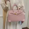 Nuevo modelo Otoño 2026, lujo ligero, elegante, bolso de mano para uso diario, bolso tipo Kelly para mujer de oficina, bolso de hombro