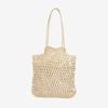 Bolso de paja de color sólido al por mayor de fábrica, nuevo bolso de paja hueca, bolso tejido, bolso de playa para vacaciones en la playa, bolso de hombro de moda