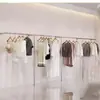 Arara de Exposição para Loja de Roupas Aço Inoxidável Metal Escovado Arara de Parede para Exposição de Roupas Femininas e Infantis