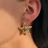 Accesorios transfronterizos europeos y americanos: Pendientes sencillos y elegantes estilo ins de flor y corazón, versátiles pendientes metálicos de estrella de mar lisa de lava