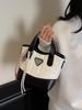 Bolsa balde de mão de linha bordada Lingge 2025 nova bolsa de ombro estilo ocidental que combina com tudo bolsa mensageiro popular de ponta para comércio exterior