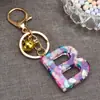 Venta caliente transfronteriza de moda 26 letras inglesas colgante de llave llavero de resina colgante creativo para bolsa de pareja