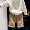 Ropa infantil estilo coreano 2026 otoño e invierno nuevo suéter de punto texturizado color blanco roto vintage pantalones casuales color caqui para niños