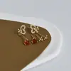 Una tarjeta tres pares de pendientes de combinación de moda lazo simple micro incrustado circonita pasador S925 pendientes al por mayor