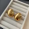Brincos grandes metálicos europeus e americanos brilhantes tridimensionais simples para mulheres, brincos de luxo leve de nicho, brincos de design exagerado, moda