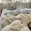 Juego de ropa de cama de textiles para el hogar de Nantong, juego de cuatro piezas, sábana de algodón lavado amigable con la piel, funda de edredón, sábana bajera, juego de tres piezas para camas de dormitorios estudiantiles