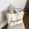Bolso de hombro casual de lona con estampado de letras estilo ins coreano para mujer, nuevo modelo 2026, bolso tote de gran capacidad