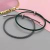 Pareja japonesa y coreana hebilla de acero de titanio ajustable cuerda de mano multicolor resistente al desgaste pulsera tejida fabricantes venta al por mayor colgante DIY