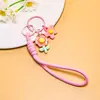 Venta al por mayor de pequeños, frescos, estilo coreano, flor de girasol acrílica, flor de goma suave, cordón trenzado hecho a mano, accesorios para cordón de teléfono