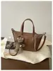 Bolso de hombro individual de temperamento simple para ir al trabajo Bolso de mano versátil de nuevo estilo transfronterizo Bolso tipo cubo Bolso cruzado casual retro Maillard