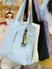 Bolso de hombro de lona de gran capacidad para mujer, nuevo modelo 2026, adecuado para el trabajo y los desplazamientos, bolso tote estilo coreano, bolso de lona