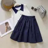 Falda midi caqui estilo universitario 2026 nuevo diseño de primavera falda midi de bolsillo estilo japonés que reduce la edad falda de línea A versión coreana