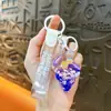 Llavero creativo de concha pequeña con aceite, lindo colgante pequeño de arena movediza líquida, accesorios para bolso, pequeño colgante de regalo, venta al por mayor